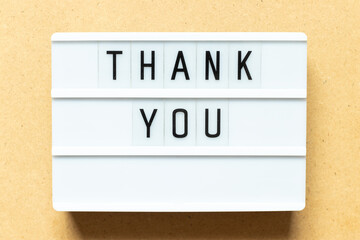 Wall Mural - Lightbox with word thank you on wood background