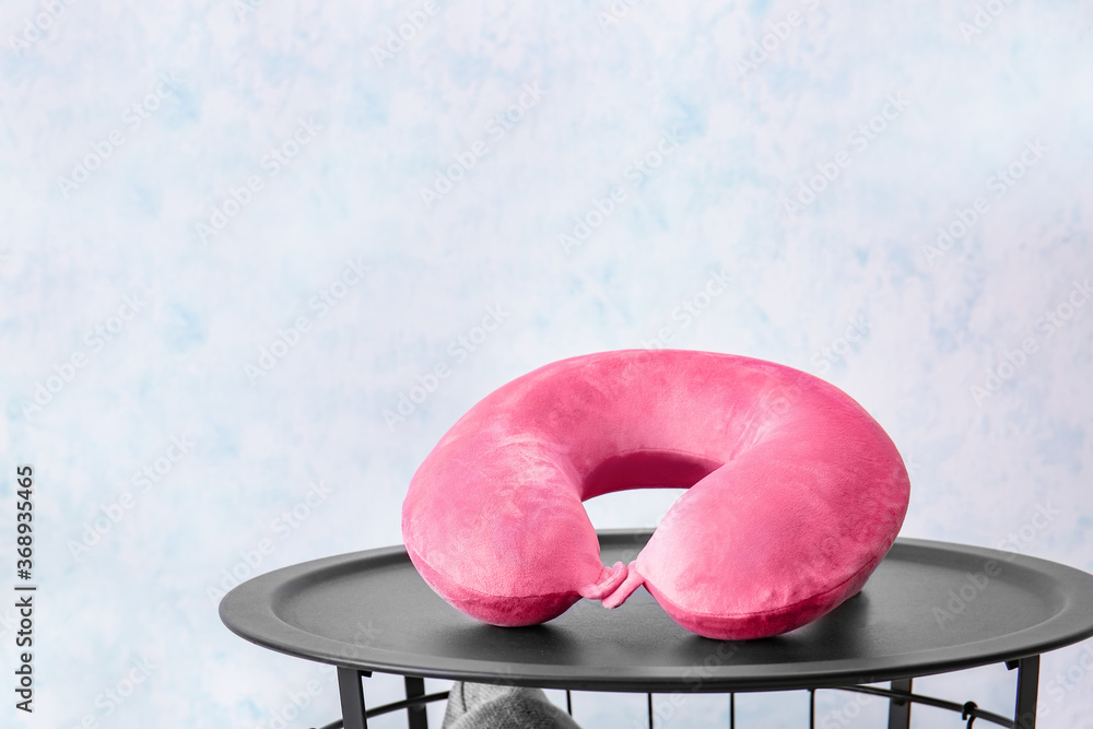 Travel pillow on table in room