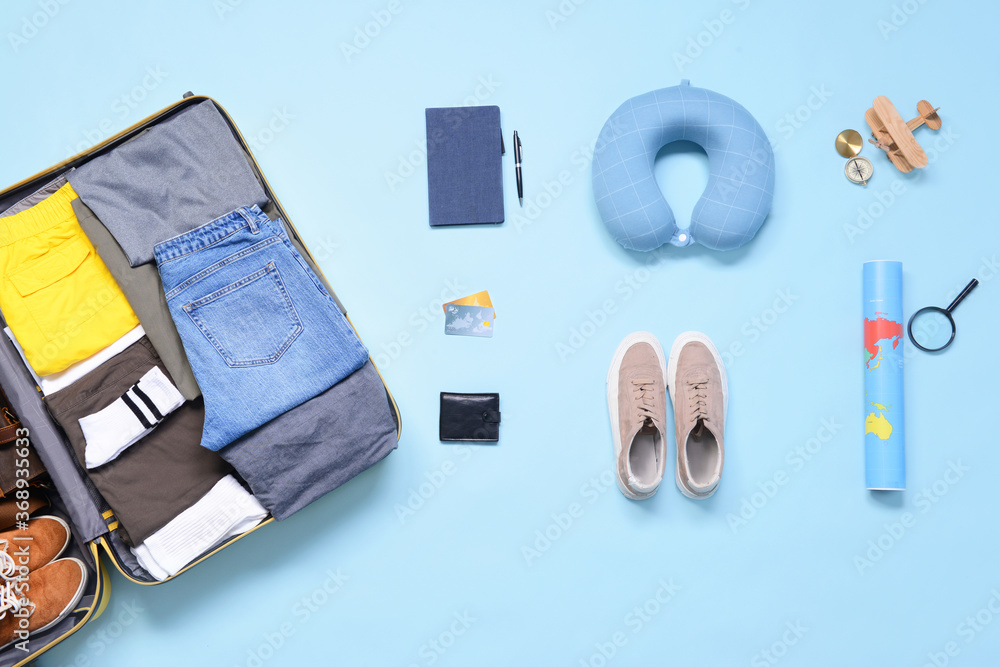 Set of travel accessories on color background