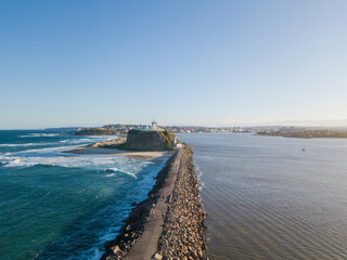 Wall Mural - Newcastle breakwall and Nobbys lighthouse on a sunny day.