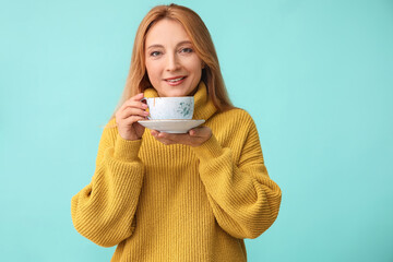 Sticker - Beautiful woman with cup of tea on color background