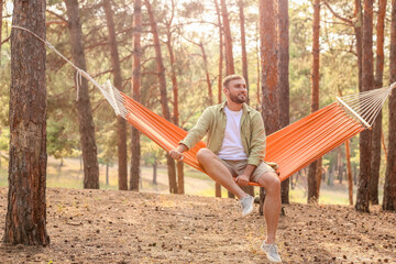 Canvas Print - Young man relaxing in hammock outdoors