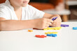 © Pixel-Shot - Little boy with autistic disorder doing puzzle at home