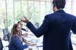 © torsakh - Business people or Manager talking with staff or colleagues and working by using headphone or headset in conference room or telecommunication meeting with customer, contact call centre office concept