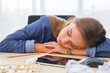 © torsakh - A women are sleeping on office desk while break time and relaxing