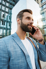 Wall Mural - Young urban businessman on smart phone