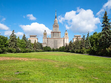 View Of The Main Building Of Moscow State University (Lomonosov State University Of Moscow) And Green Lawn In Courtyard In Sunny Summer Day