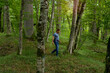© IoaBal - Adult man enjoys walking through the green forest in summer
