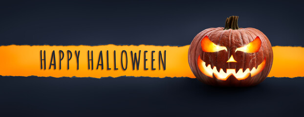 Wall Mural - the words happy halloween on a textured paper tear with a halloween lantern, jack o lantern on dark 