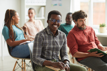 Wall Mural - multi-ethnic group of people sitting in audience during training seminar or business conference in o