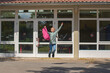 © Elena Medoks - The schoolgirl is jumping for the joy of returning to school. The beginning of the school year. Education after vacation and coronavirus epidemic