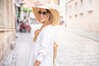 © neonshot - Happy woman on vacation wearing summer hat