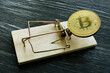 © Vitalii Vodolazskyi - Mousetrap and bitcoin coin. Cryptocurrency scam or fraud concept.