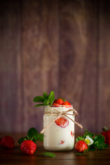 Wall Mural - sweet homemade yogurt with ripe fresh strawberries in a jar