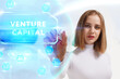 © photon_photo - Business, Technology, Internet and network concept. Young businessman working on a virtual screen of the future and sees the inscription: Venture capital