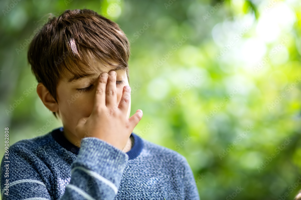 child with headache. Upset young boy outdoors - obrazy, fototapety, plakaty 