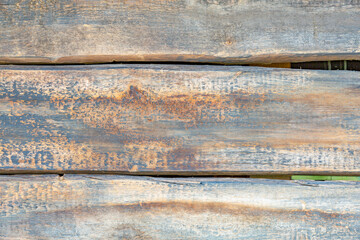 Wall in the garden made of natural wooden boards