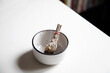 © Natalie JEFFCOTT/Stocksy - Clearing energy in home using sage / smudge stick