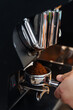 © Pietro Karras/Stocksy - Barista filing portafilter with fresh coffee