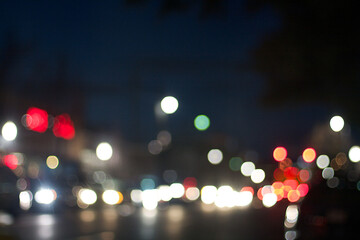 Wall Mural - A city scene with lots of blurred lights creating bokeh from traffic