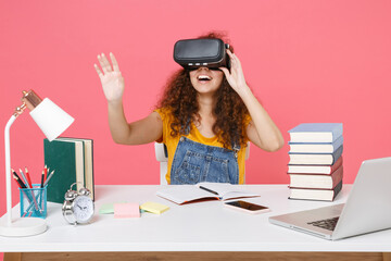 Canvas Print - African american girl employee in office isolated on pink background. Achievement business career. Education in school university college concept. Watching in headset touch something push on button.