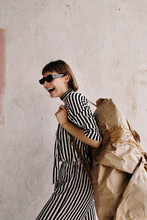 Laughing Artistic Woman Carrying Abstract Baggage