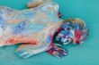 © Liliya Rodnikova/Stocksy - Model with painted body lying on belly