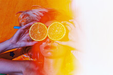 Blonde Woman On Colorful Beach Towel With Oranges And Lemons On Eyes Or Hiding Eyes In Summer In 1980s Colors