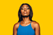 © MyMicrostock/Stocksy - Beautiful Afro Woman posing over yellow background