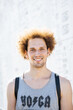 © Ivan Ozerov/Stocksy - Portrait of a young curly man in a gray shirt