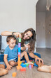 © Santi Nunez/Stocksy - Mother playing with her son at home