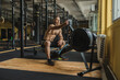 © JAVIER PARDINA/Stocksy - Strong and healthy man working out on a rowing machine, inside a crossfit gym.