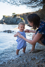 Cute Baby Boy And His Mother On A Beach On The French Riviera