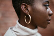 © BONNINSTUDIO/Stocksy - Black woman with shiny earring