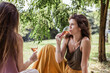 © Painted Wood/Stocksy - Beautful woman drinking wine on a picnic