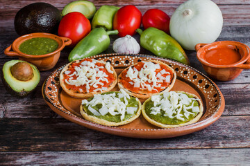 Wall Mural - Mexican sopes with grated cheese and salsa, Traditional breakfast in Mexico