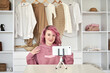 © insta_photos - Happy hipster gen z teen girl fashion social media channel blogger with pink hair wear hoodie speaking recording video blog on phone video camera vlog tutorial sit near clothes wardrobe closet.
