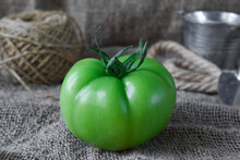 Close Up Of One Unripe Green Tomato