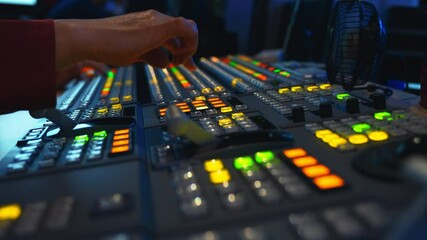 Wall Mural - Broadcast Tv Studio Production - Vision Switcher Studio Director broadcast video mixer operation - Close-up of hand. Hands of a cinematographer who worked on the vision mixer, switch the TV panel.