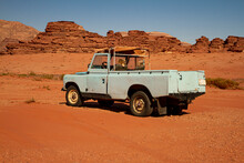  A Vintage Turquoise Colored Pick Up Truck Is Abandoned On Red Sands Of The Wadi Rum Desert. This Is A Very Old And Rusty Vehicle, Poorly Maintained And Is Broken Down.