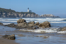 Yaquina Head Lighthouse In Oregon With Rocky Beach