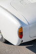 © David Keller/Stocksy - The taillight of a classic white car