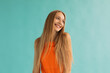 © Sergey Filimonov/Stocksy - Content teen blonde smiling on turquoise background