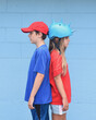 © Angela Waye/Stocksy - Children Standing Back to Back