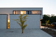 © KOEN VAN DAMME/Stocksy - modern house at dusk