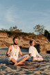 © Danil Nevsky/Stocksy - Couple meditating on sandy shore