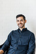 © Lauren Edmonds/Stocksy - Headshot of young man in bright modern home