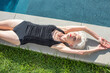 © Ivan Solis/Stocksy - Senior woman by the pool