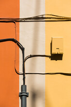Old Electrical Wires Against Colorful Painted Walls
