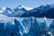 © EZ PHOTOS - Closeup of ice rocks surrounded by snowy mountains at Perito Moreno Glacier in Argentina. Global warming and climate change concept.